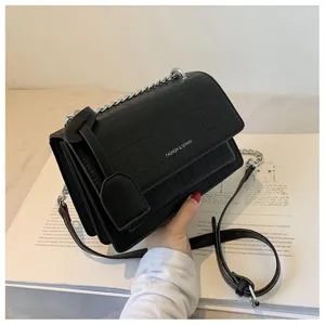 Stylish black crocodile pattern shoulder crossbody bag with metal chain strap detail.