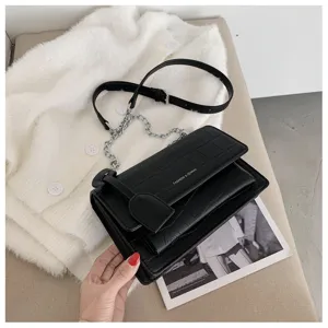 Black crocodile pattern chain shoulder bag with flap design and metal strap detail for women.