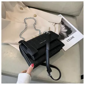 Black crocodile texture crossbody shoulder bag with chain strap and elegant chic design detail.