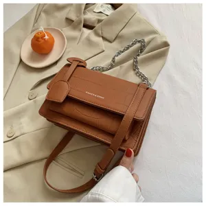Brown crocodile pattern leather crossbody shoulder bag with stylish chain strap for women.