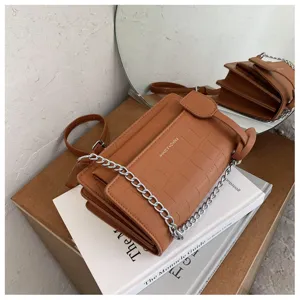 Detailed view of the stylish brown crocodile pattern women shoulder bag with silver chain strap.