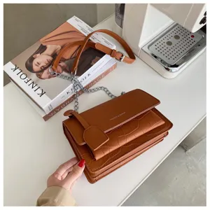 Brown crocodile pattern cross-body bag with chain strap and flap closure for women stylish.