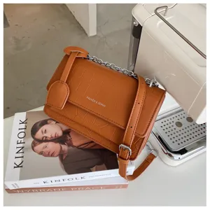 Stylish brown stone pattern crossbody bag with chain strap, compact casual shoulder bag.