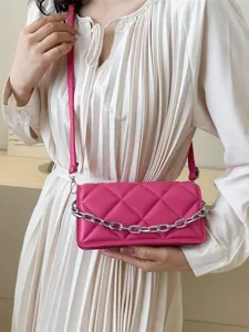 Chic pink quilted crossbody bag for women with silver chain strap and stylish design.