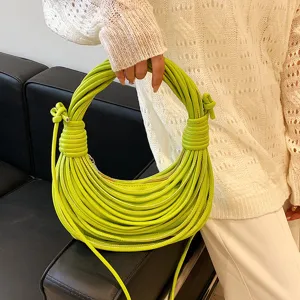 Close-up view of the neon green knotted handle hobo bag with unique multi-strand cord design.
