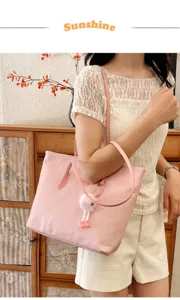 Pink embossed tote bag for women, large capacity casual shoulder bag with cute fluffy charm.