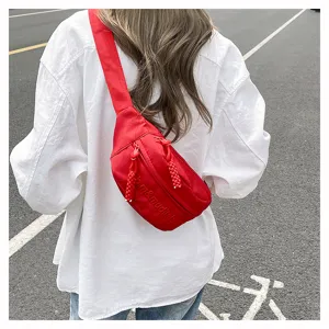 Red solid color chest bag and casual waist bag with letter embossing detail for daily street style.