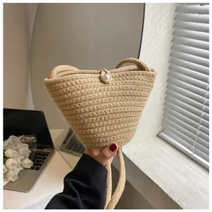 Woven straw bucket bag for women stylish casual crossbody bag with pearl closure summer beach.