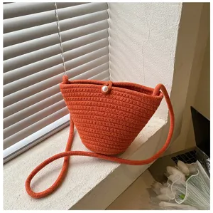 Orange woven crossbody bucket bag with pearl detail, casual style, perfect for daily wear.