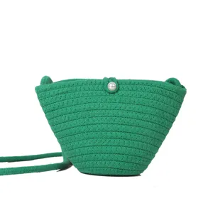 Green woven bucket bag detail, cotton rope crossbody phone bag with pearl button.