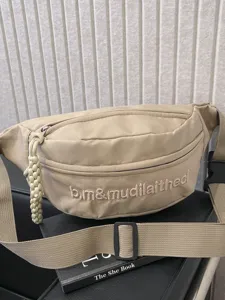 Solid color fashion chest bag streetwear casual fanny pack with letter embroidery.