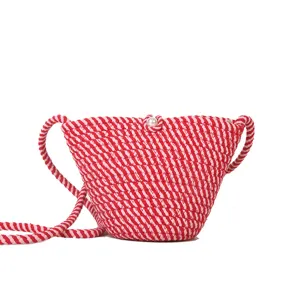 Red and white striped woven crossbody bucket bag with cute pearl button closure detail.