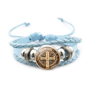 Detailed view of the Saint Benedict medal braided leather bracelet with vintage metal beads.