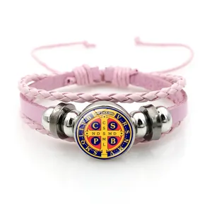 Pink braided leather bracelet featuring a classic round Saint Benedict medal charm and metal beads.