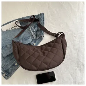 Detailed view of brown quilted nylon crescent shoulder bag, casual dumpling crossbody design.