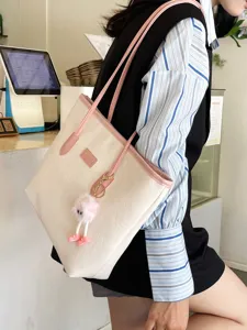 Large capacity color-block tote bag for women, stylish PU leather shoulder handbag with cute charm.