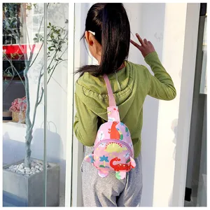 Cute cartoon dinosaur chest bag detail showing lovely pink fabric and playful dinosaur prints.