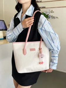 Large capacity color block tote bag for women, stylish embossed shoulder bag and commuter bag.