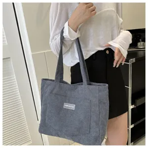 Corduroy tote bag front pocket detail showing texture and label, perfect casual daily use.