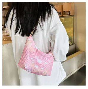 Pink quilted underarm bag detail, soft nylon material, stylish gold chain strap, daily chic wear.