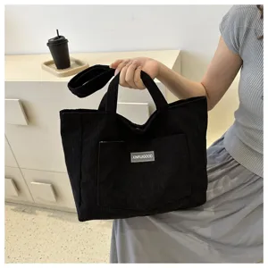 Black corduroy tote bag for women, large capacity shoulder handbag with front pocket stylish.