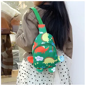Cute green cartoon dinosaur sling bag detail, featuring 3D limbs and soft fabric for kids.