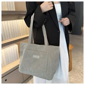 Detailed view of the casual corduroy tote bag with front pocket and shoulder straps.