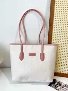 Color-contrast tote bag with cute embossed patterns and pink handles for women commuter.