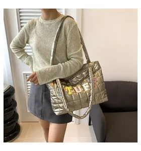 Metallic quilted puffer tote bag detail, stylish shoulder handbag with colorful letter patches.