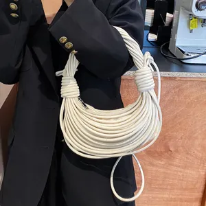 Detailed shot of the unique knotted rope hobo shoulder bag in cream white, stylish handbag.