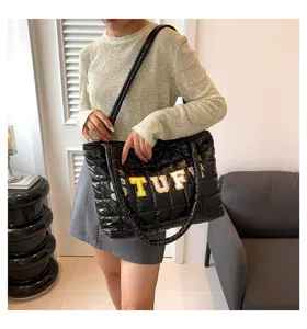 Black quilted puffer tote bag for women, large capacity casual shoulder bag with letter patch.