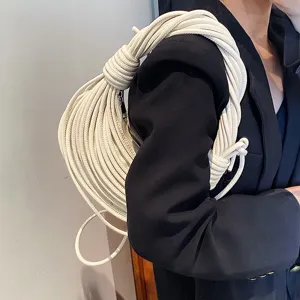 Detail view of white knotted noodle shoulder bag, unique handcrafted design for women.