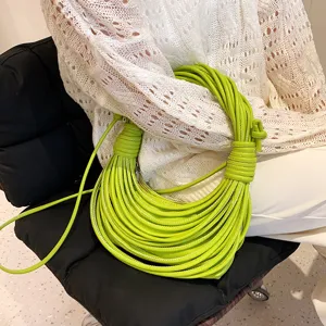 Detailed view of lime green multi-cord braided shoulder bag, stylish knotted handle design.