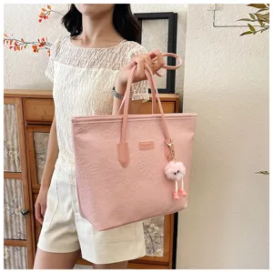 Pink embossed tote bag for women, large capacity shoulder bag with cute furry charm for daily use.