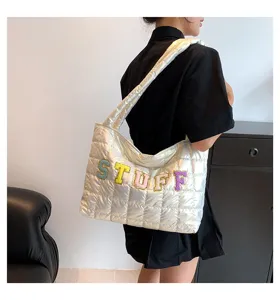 Silver quilted shoulder tote bag with colorful letter patches, stylish winter down cotton handbag.