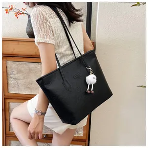 Black large capacity tote bag with chic debossed pattern and cute plush charm for daily commuting style.