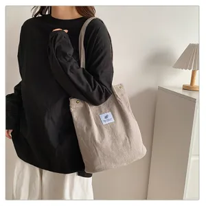 Detailed view of casual corduroy shoulder tote bag, large capacity canvas fabric daily handbag.