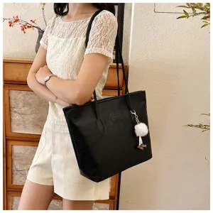 Women large capacity black tote shoulder bag with cute fluffy charm, embossed design stylish.