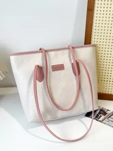 White tote bag with pink straps, embossed texture and large capacity for daily commuting.