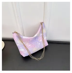 Detailed view of the gradient purple quilted shoulder bag with shiny gold chain strap.