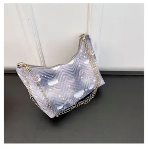 Close-up detail view of quilted nylon underarm shoulder bag with cute butterfly and rainbow print.