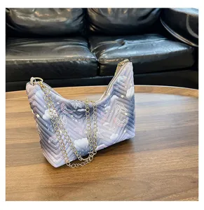 Gradient puffer underarm shoulder bag with cute cloud rainbow print and gold chain strap.