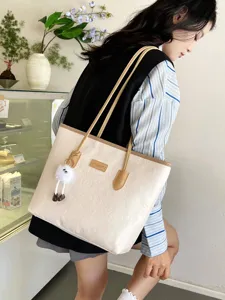 Detail view of the stylish beige tote shoulder bag for women, featuring embossed patterns and chic charm.