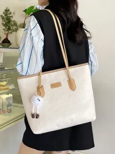 Large capacity women tote bag, color contrast shoulder bag with cute pendant and embossed design.