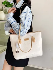 Large capacity contrast color shoulder tote bag for women with embossed design and cute charm.
