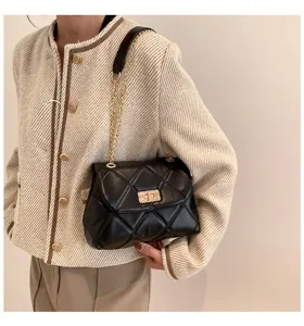 Black quilted leather shoulder bag with gold chain strap for women, elegant daily commute.