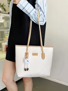 Detailed view of the large capacity contrast color tote bag with elegant embossing and fluffy charm.