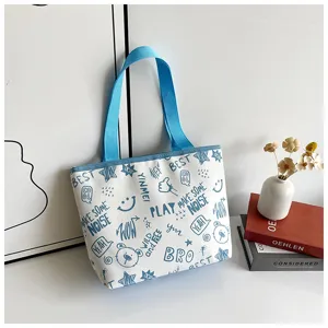Casual white canvas tote bag with blue straps and stylish graphic doodle prints for daily use.