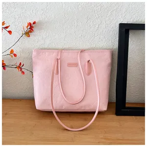 Pink tote bag detail view, embossed pattern, daily commuting style, elegant shoulder bag.