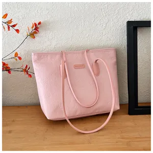 Pink large capacity tote bag for women, featuring chic embossed patterns and double shoulder straps.